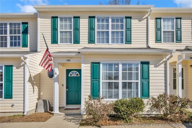 front view of a brick house with a windows