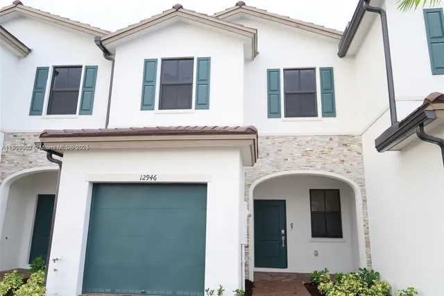 a front view of a house with large windows