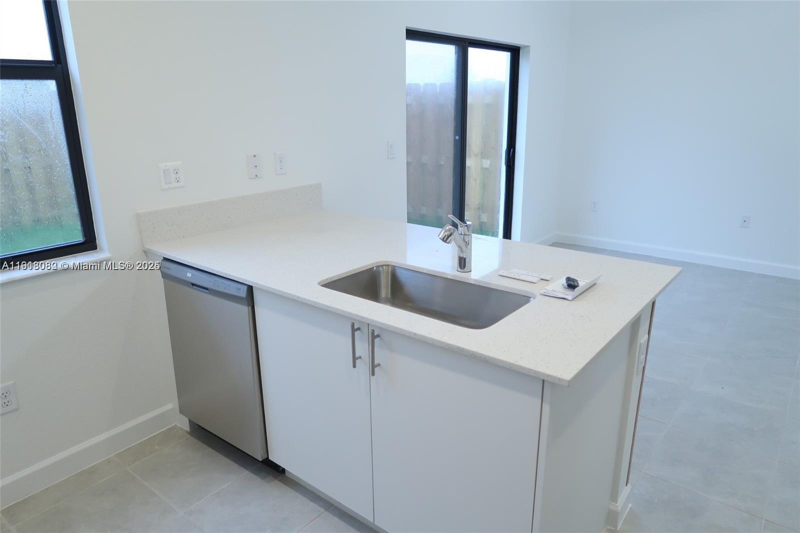 12946 Southwest 231st Street Miami, FL 33170 - Photo 16 of 42 a kitchen with a sink and a refrigerator