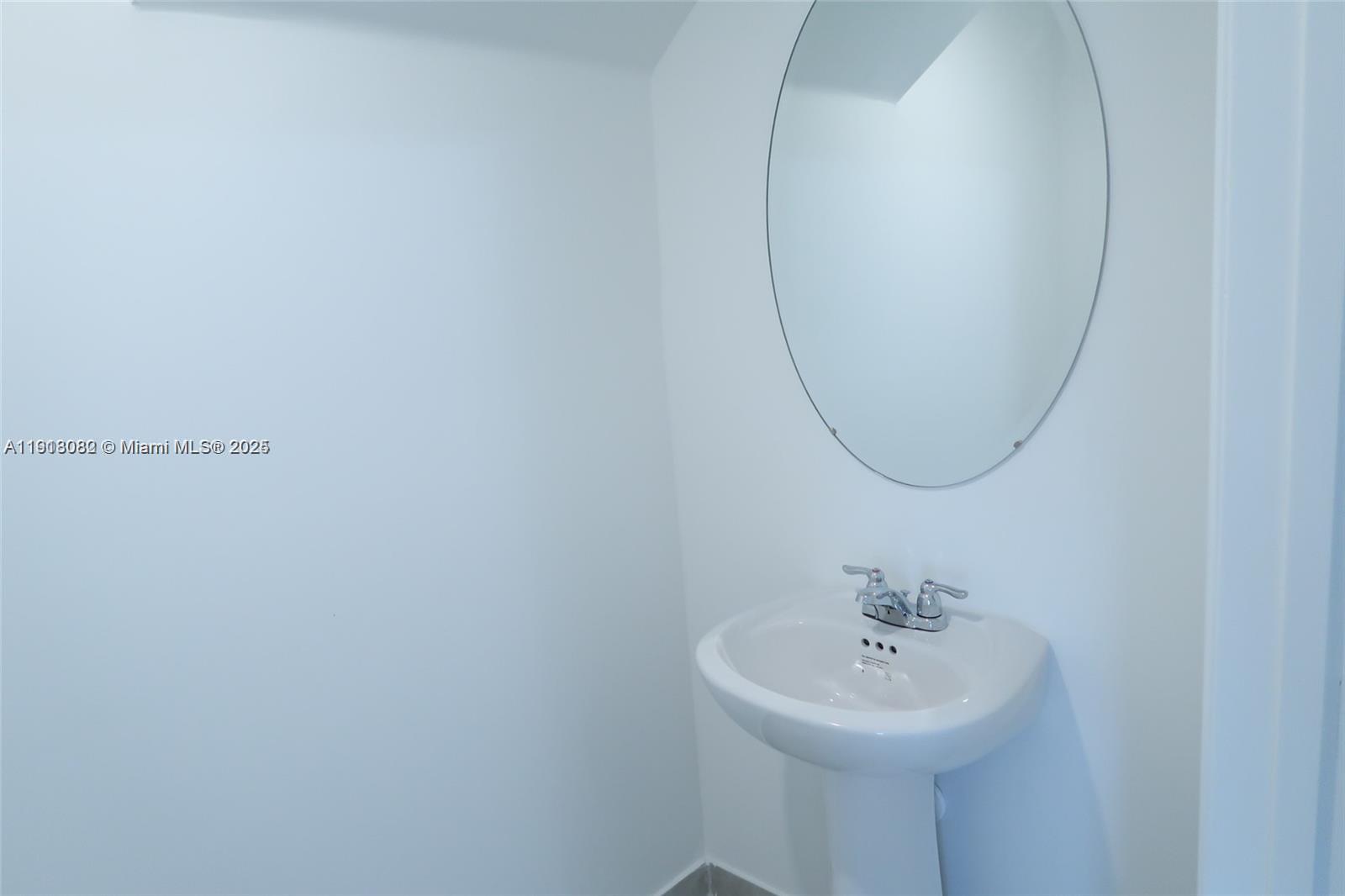 12946 Southwest 231st Street Miami, FL 33170 - Photo 20 of 42 a bathroom with a sink a mirror and a toilet