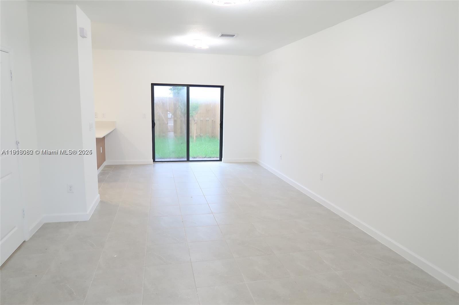 12946 Southwest 231st Street Miami, FL 33170 - Photo 3 of 42 a view of an empty room with window
