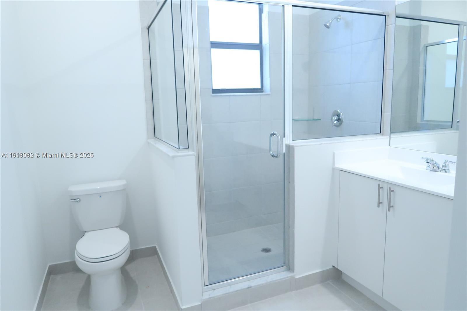 12946 Southwest 231st Street Miami, FL 33170 - Photo 37 of 42 a bathroom with a toilet sink and shower