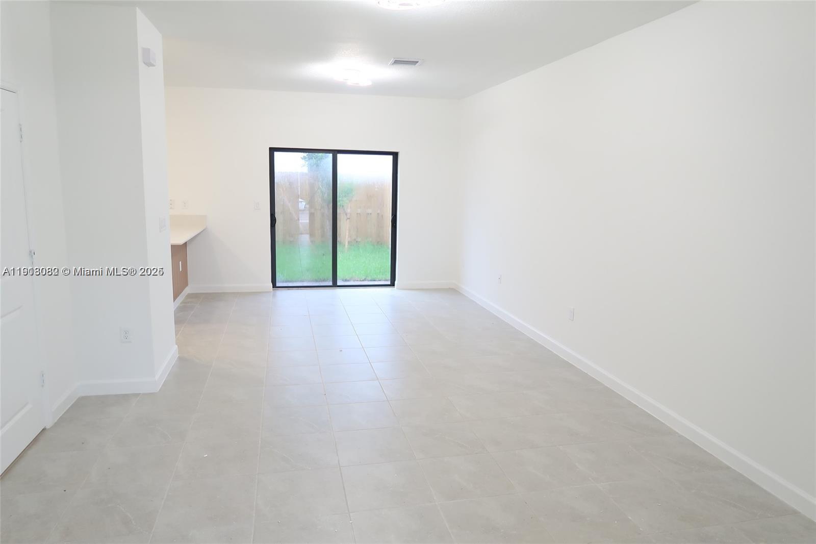 12946 Southwest 231st Street Miami, FL 33170 - Photo 4 of 42 a view of an empty room with window