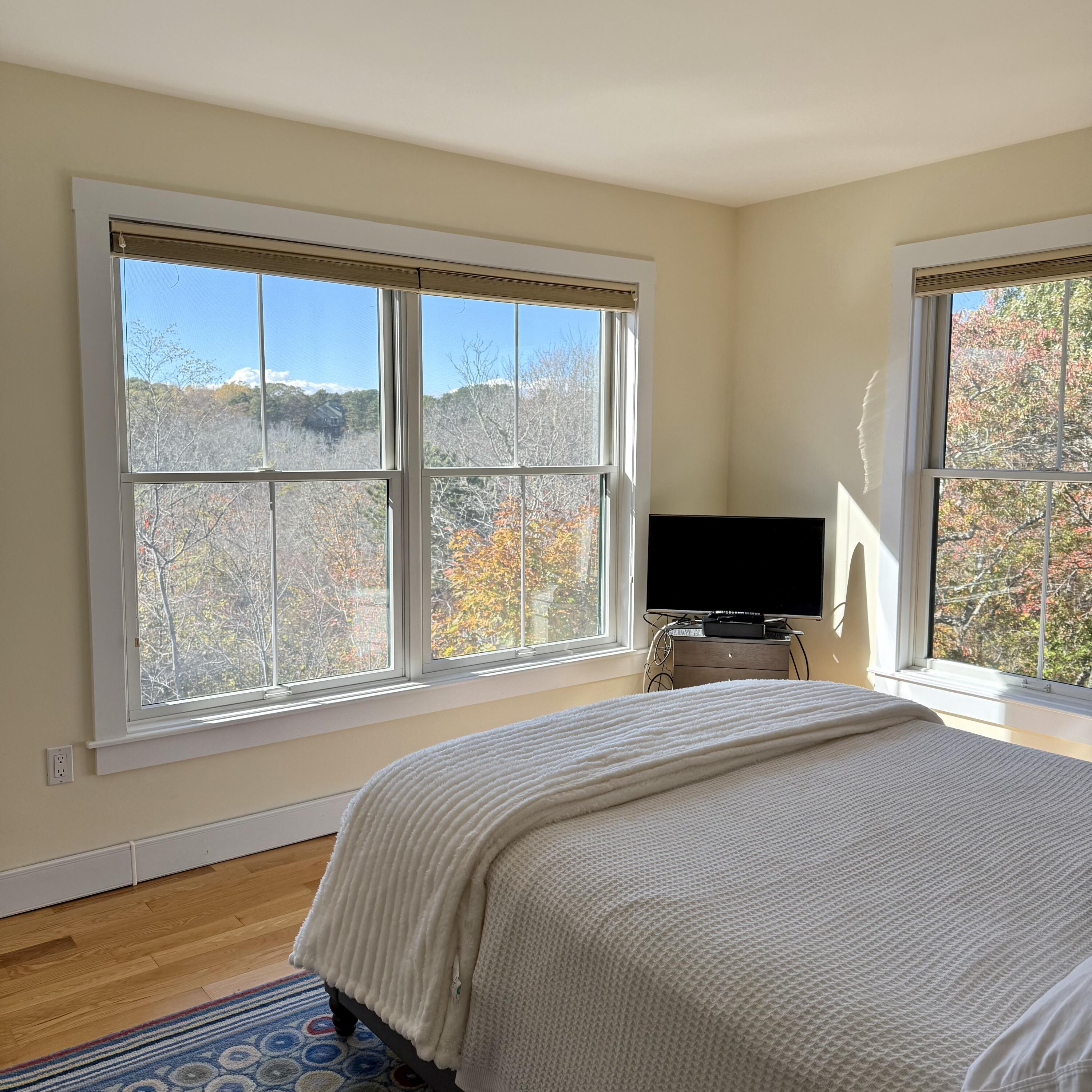 16 Meadow Road, Unit 16 Provincetown, MA 02657 - Photo 11 of 23 a bedroom with a bed and a flat screen tv
