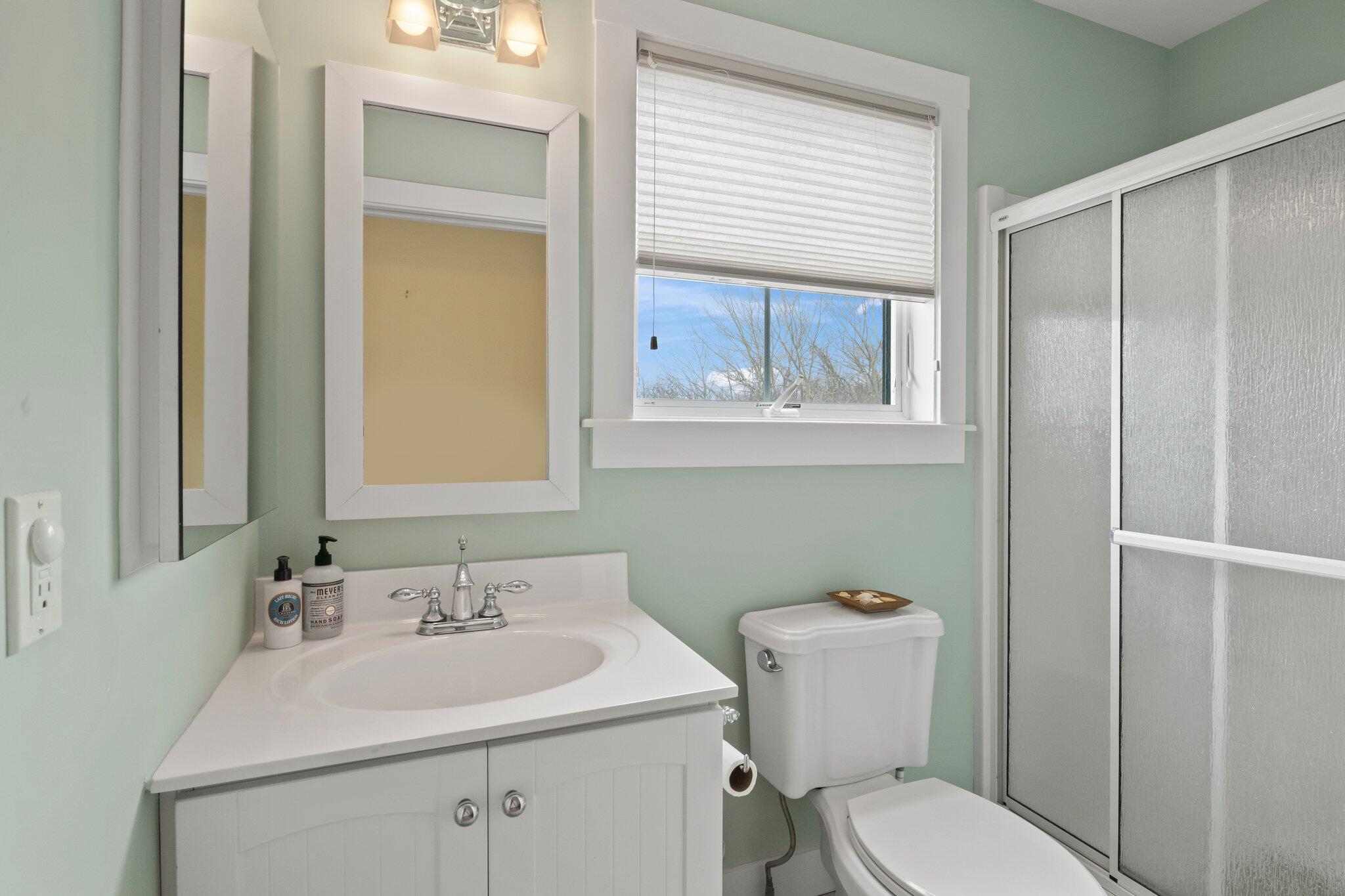 16 Meadow Road, Unit 16 Provincetown, MA 02657 - Photo 16 of 23 a bathroom with a toilet a sink and mirror