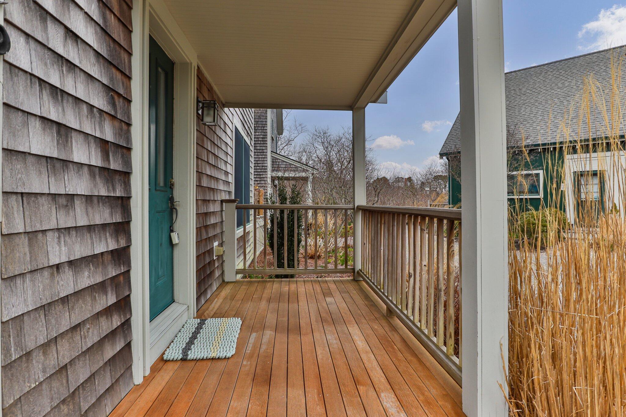 16 Meadow Road, Unit 16 Provincetown, MA 02657 - Photo 20 of 23 a view of a balcony with wooden floor and fence