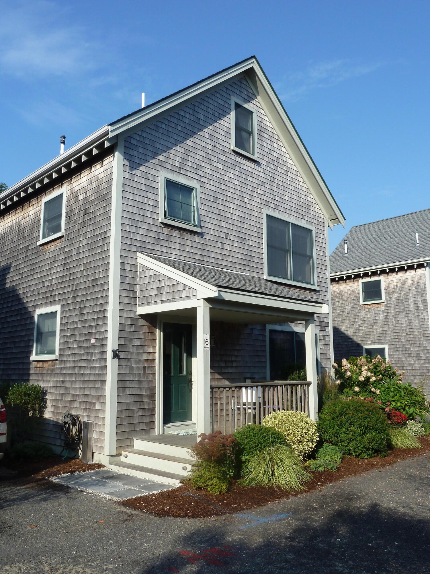 16 Meadow Road, Unit 16 Provincetown, MA 02657 - Photo 21 of 23 a front view of a house with a yard