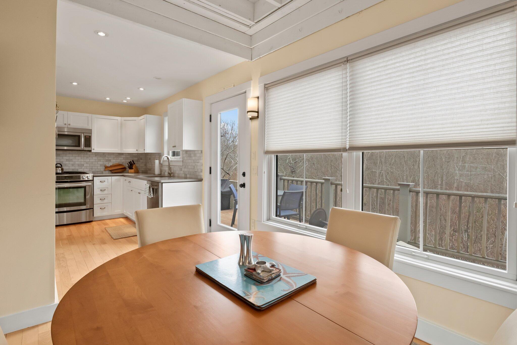 16 Meadow Road, Unit 16 Provincetown, MA 02657 - Photo 23 of 23 a living room with furniture a large window and kitchen view
