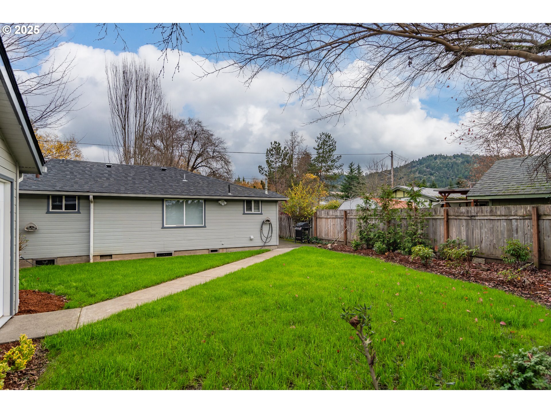 512 West Center Street Roseburg, OR 97471 - Photo 19 of 48 a view of a back yard of the house with a garden