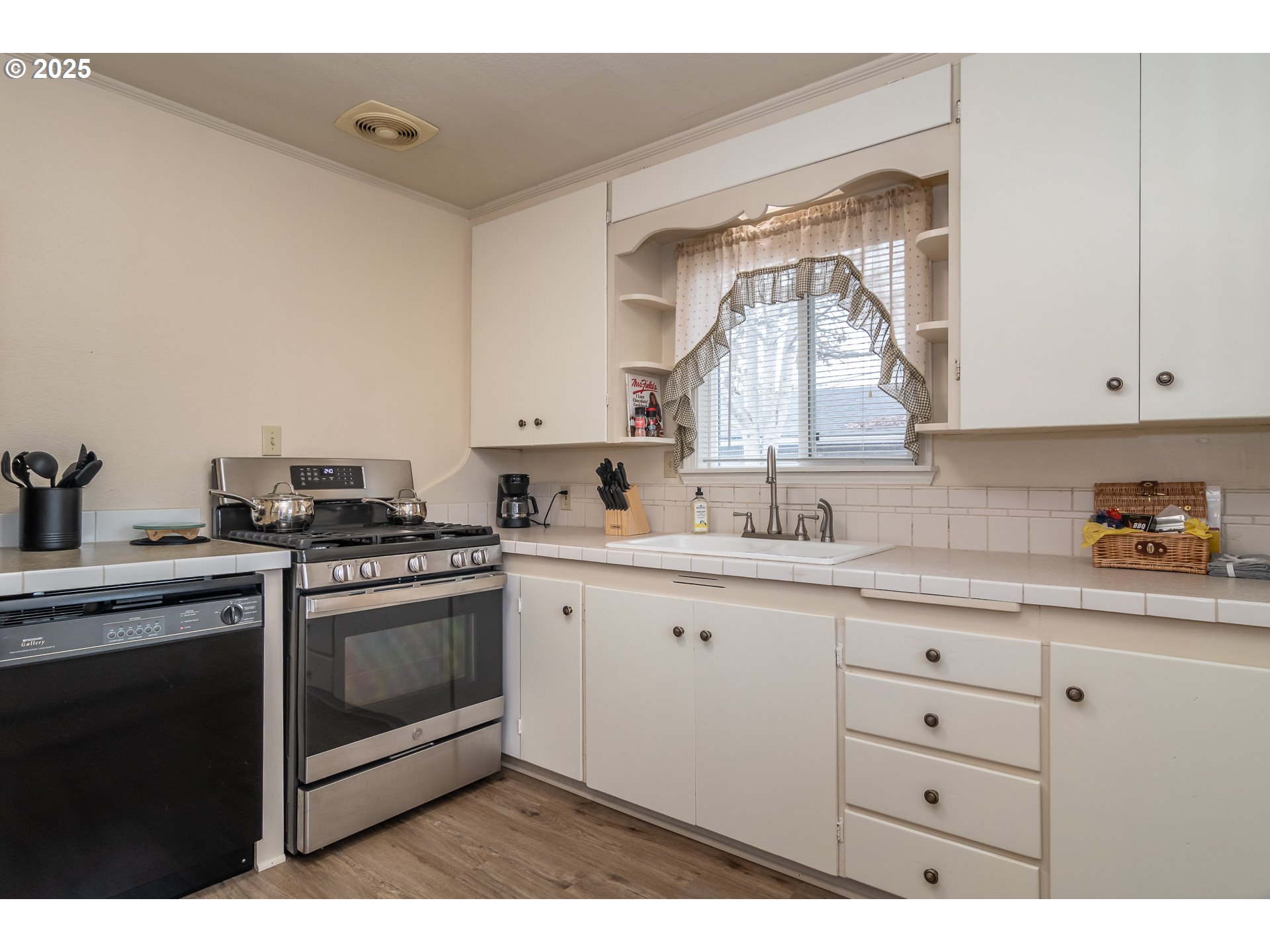 512 West Center Street Roseburg, OR 97471 - Photo 27 of 48 a kitchen with granite countertop white cabinets and white appliances