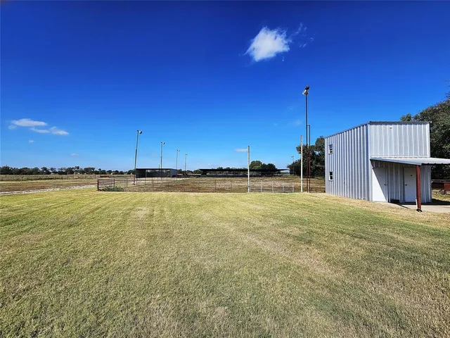 a view of a house with pool and a bench