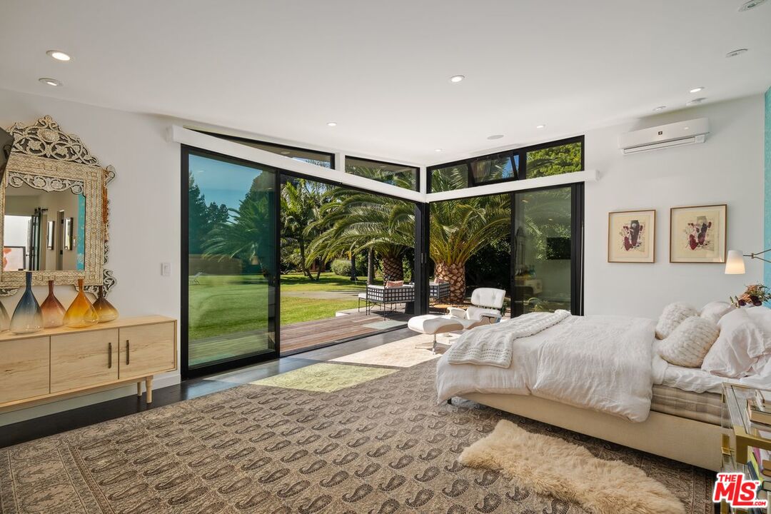 6237 Bonsall Drive Malibu, CA 90265 - Photo 15 of 50 a living room with a large bed and a large window