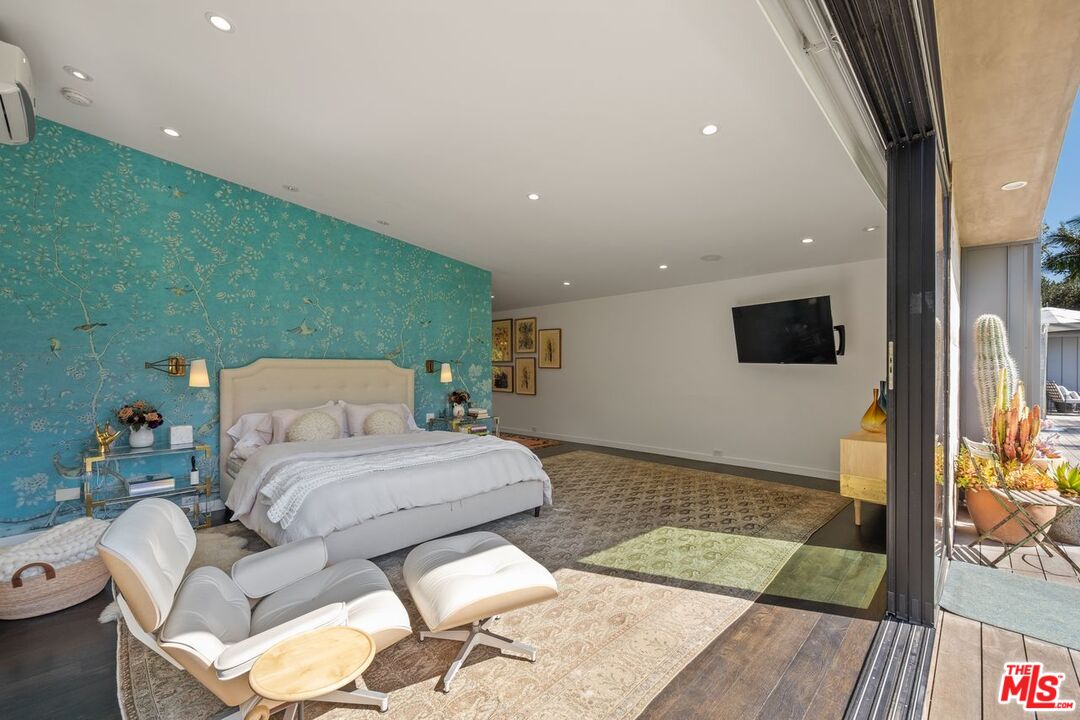 6237 Bonsall Drive Malibu, CA 90265 - Photo 17 of 50 a spacious bedroom with a bed and a flat screen tv