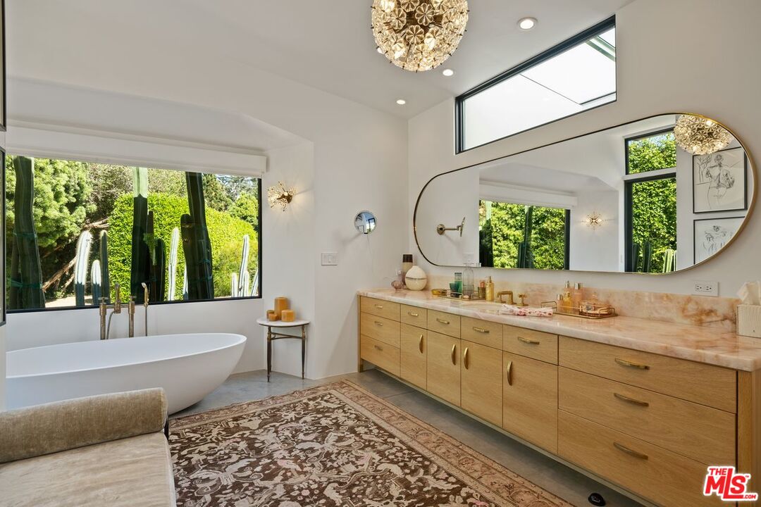 6237 Bonsall Drive Malibu, CA 90265 - Photo 20 of 50 a bathroom with a double vanity sink a mirror and a bathtub