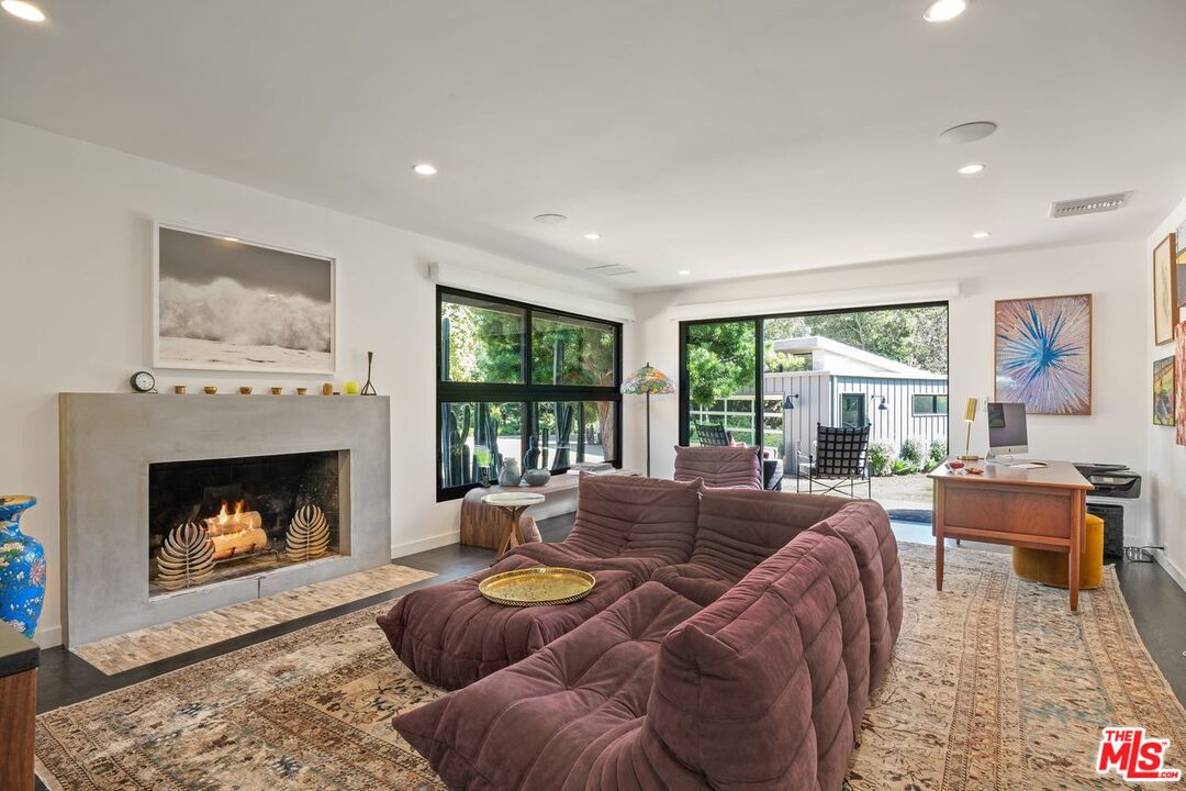 6237 Bonsall Drive Malibu, CA 90265 - Photo 24 of 50 a living room with furniture and a fireplace