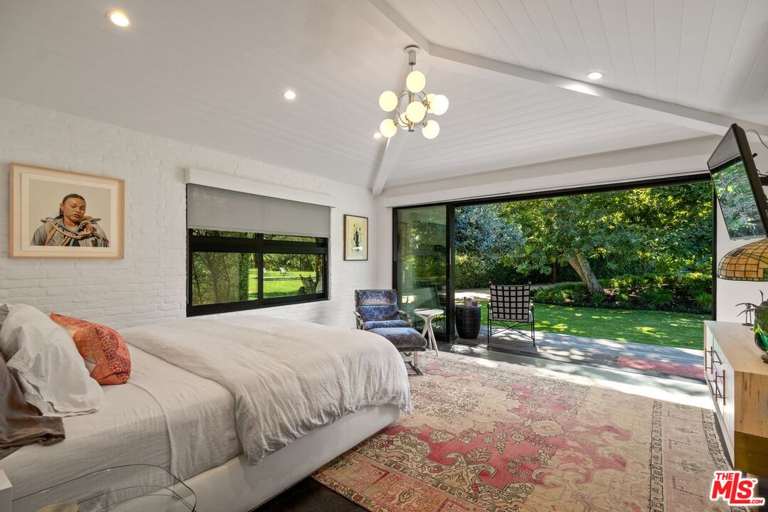 6237 Bonsall Drive Malibu, CA 90265 - Photo 29 of 50 a bedroom with a bed and large windows
