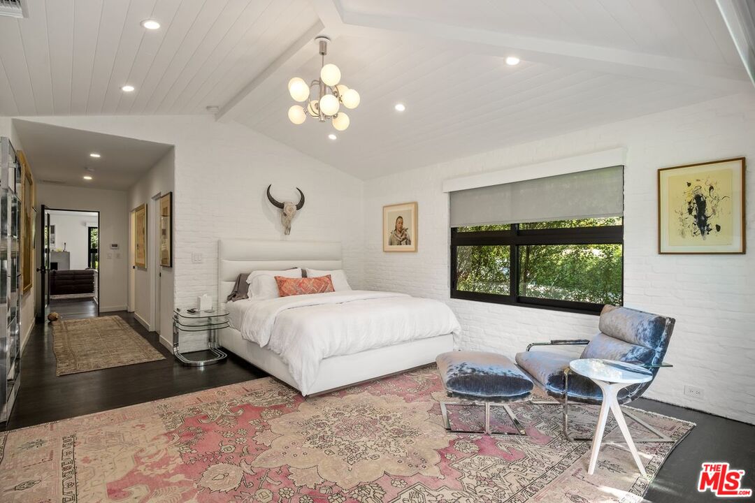 6237 Bonsall Drive Malibu, CA 90265 - Photo 30 of 50 a bedroom with a bed and a chandelier