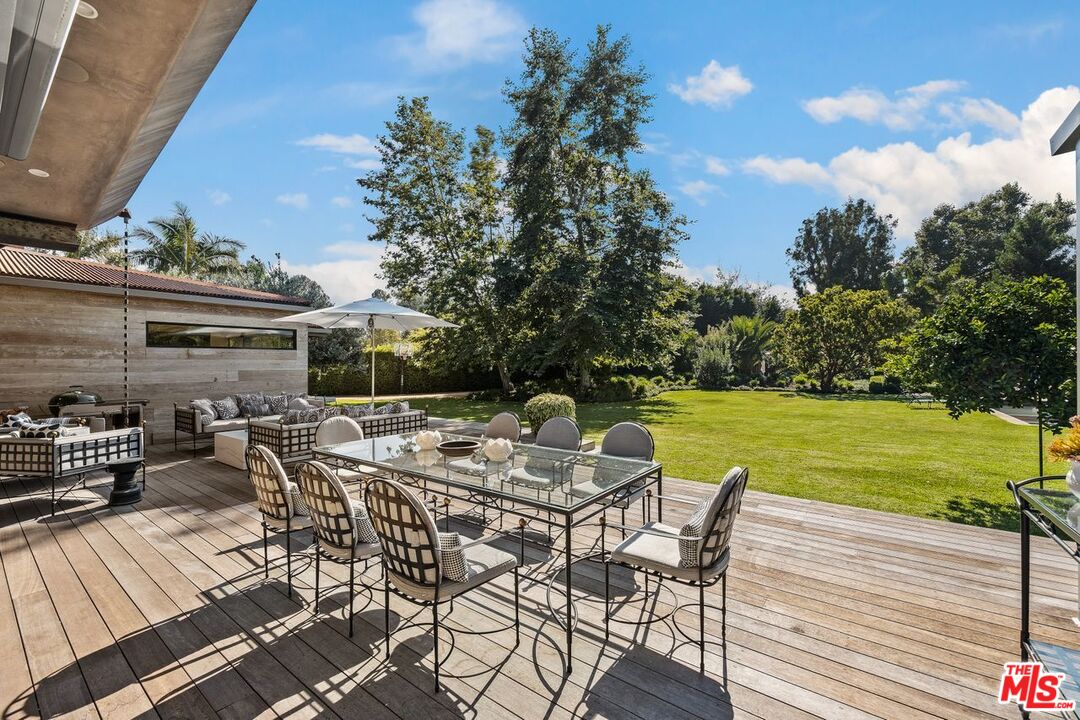 6237 Bonsall Drive Malibu, CA 90265 - Photo 33 of 50 a view of a patio with table and chairs and potted plants