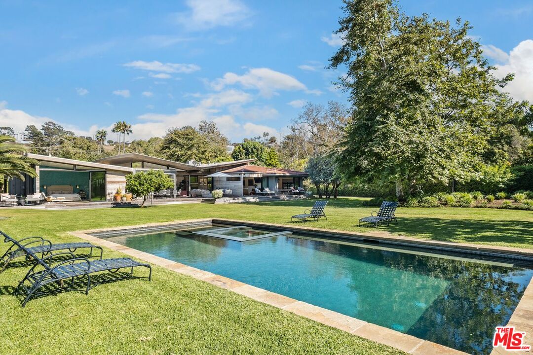 6237 Bonsall Drive Malibu, CA 90265 - Photo 42 of 50 a view of a swimming pool with a lawn chairs