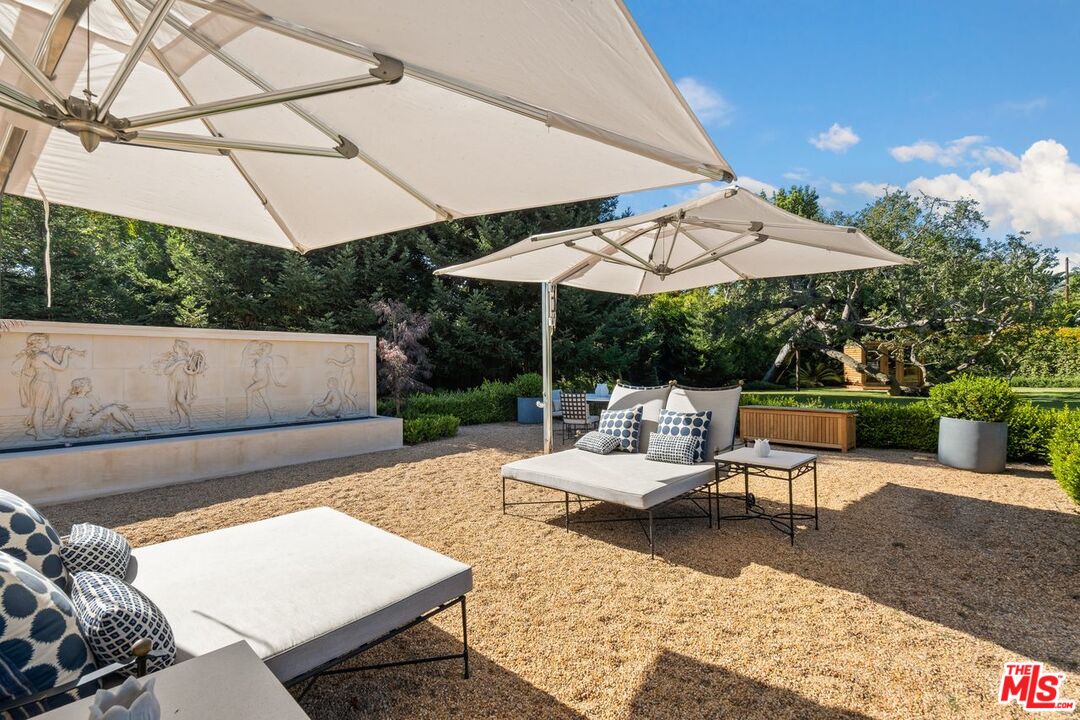 6237 Bonsall Drive Malibu, CA 90265 - Photo 43 of 50 a view of patio with couches table and chairs under an umbrella