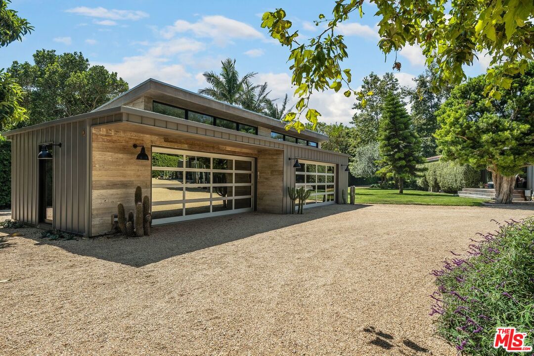 6237 Bonsall Drive Malibu, CA 90265 - Photo 48 of 50 a view of a house with a yard and garage