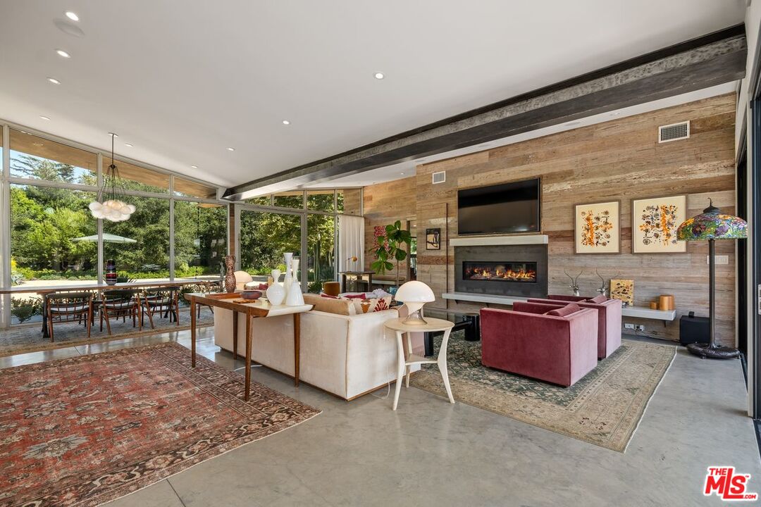 6237 Bonsall Drive Malibu, CA 90265 - Photo 8 of 50 a living room with furniture a large window and a fireplace