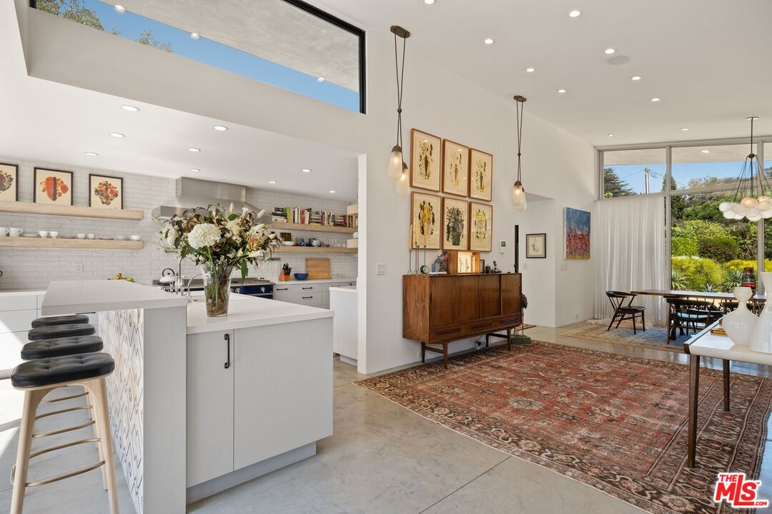 6237 Bonsall Drive Malibu, CA 90265 - Photo 10 of 50 a living room with stainless steel appliances furniture a rug and a kitchen view