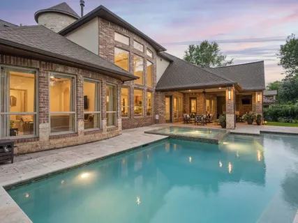 a view of a swimming pool with outdoor seating