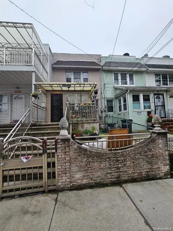 a front view of a building with parked cars