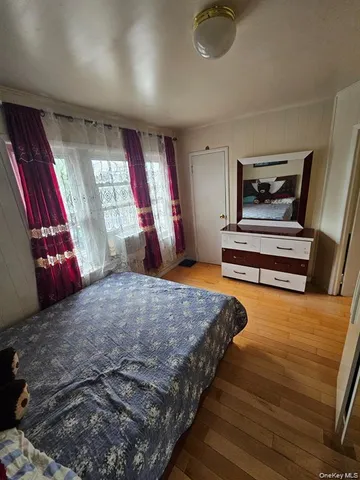 a bedroom with a bed and window