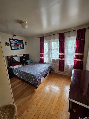 a bedroom with bed and window
