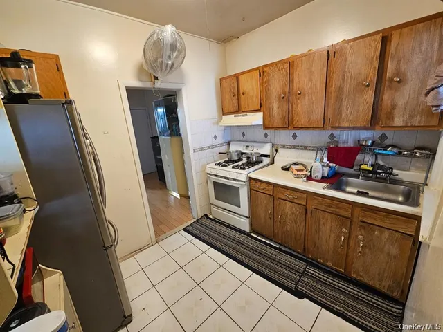 a kitchen with sink cabinets and appliances