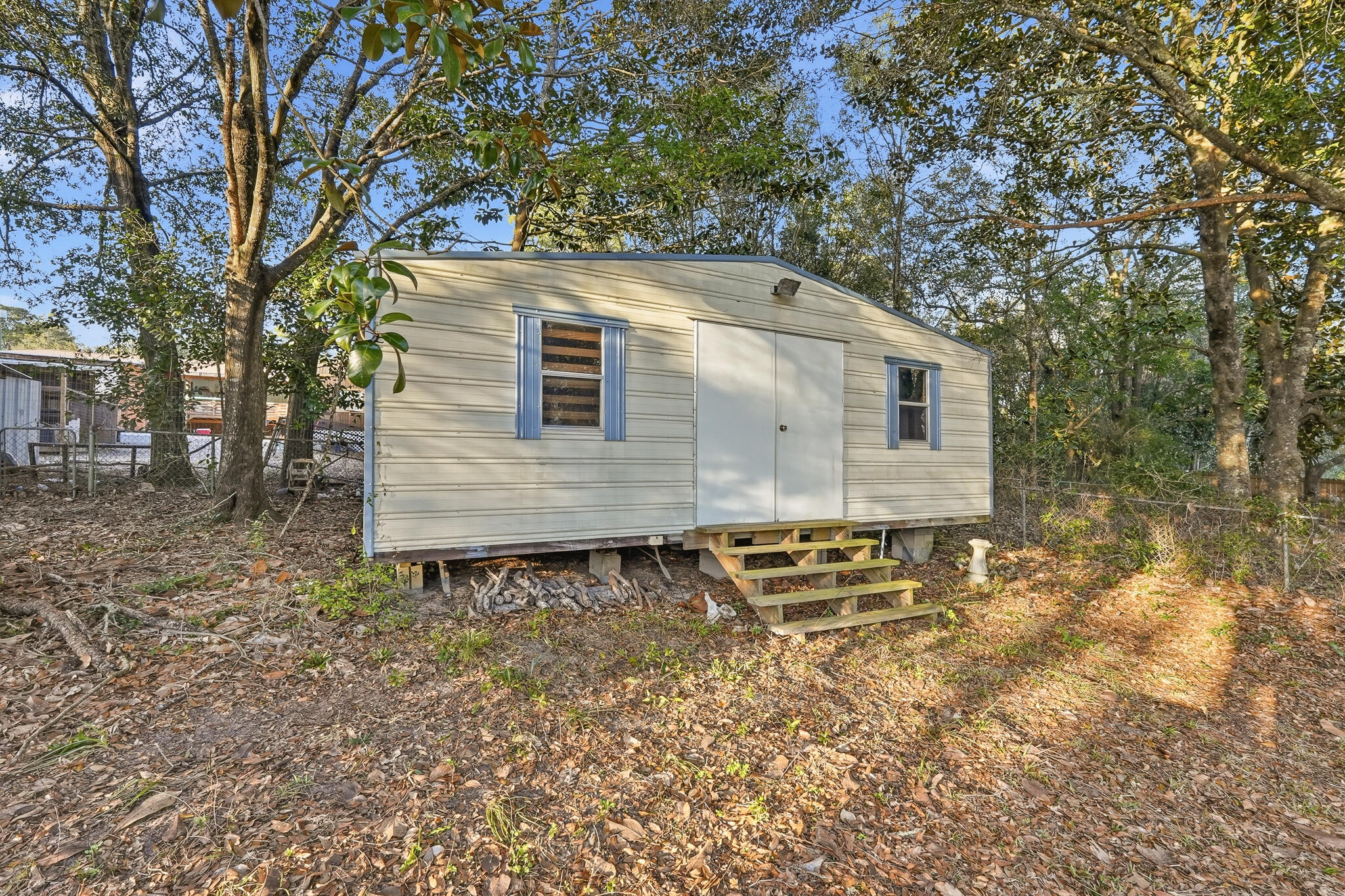 271 Willow Avenue Freeport, FL 32439 - Photo 19 of 57 a brick house with a large tree
