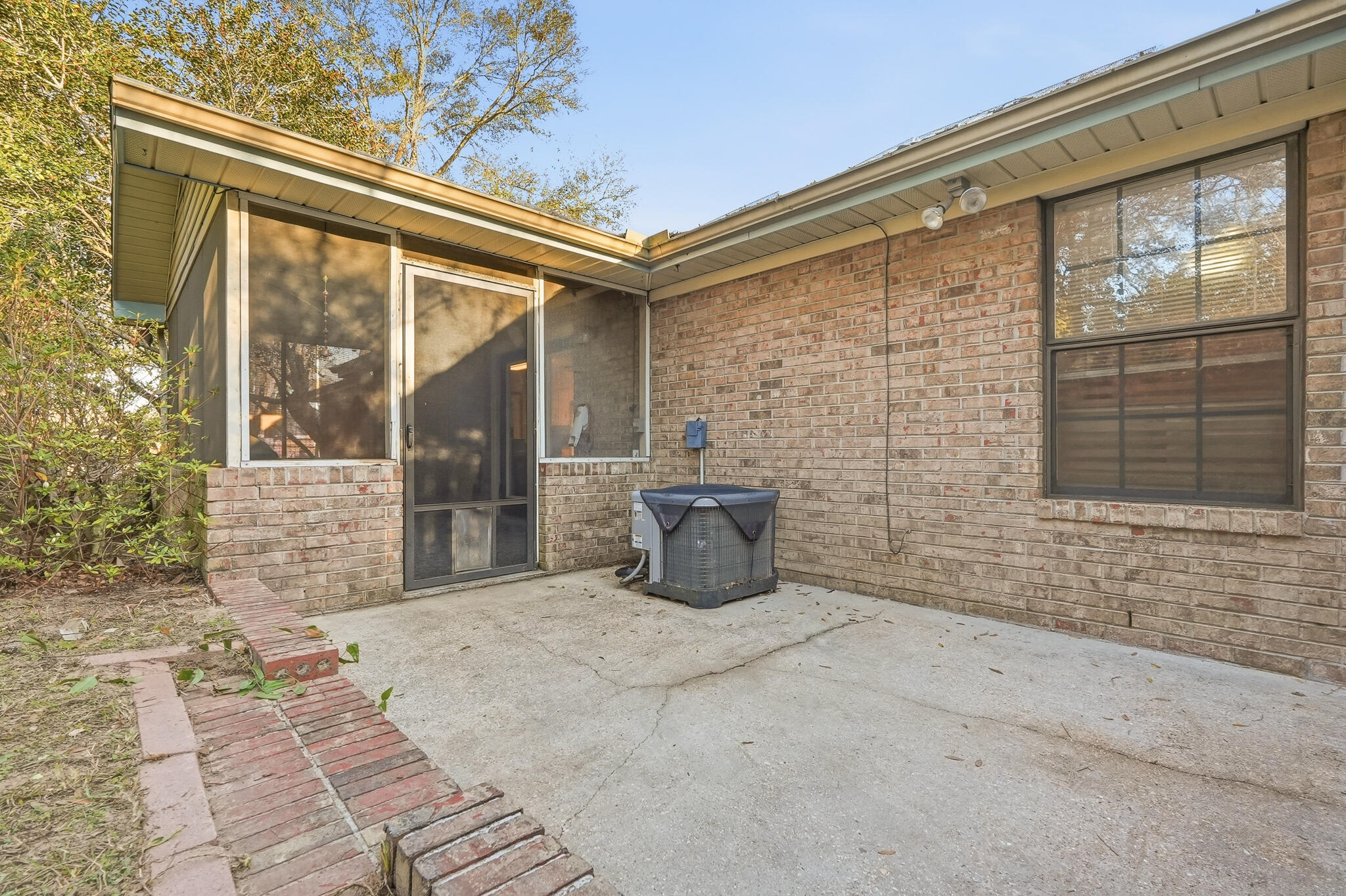 271 Willow Avenue Freeport, FL 32439 - Photo 23 of 57 a view of a brick house with a large window