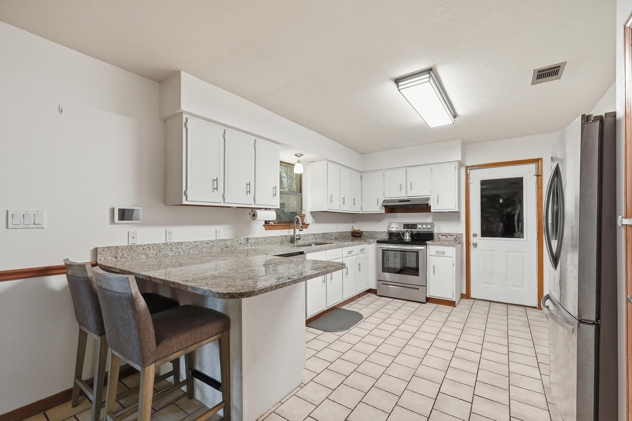 271 Willow Avenue Freeport, FL 32439 - Photo 30 of 57 a kitchen with a stove a sink and a refrigerator