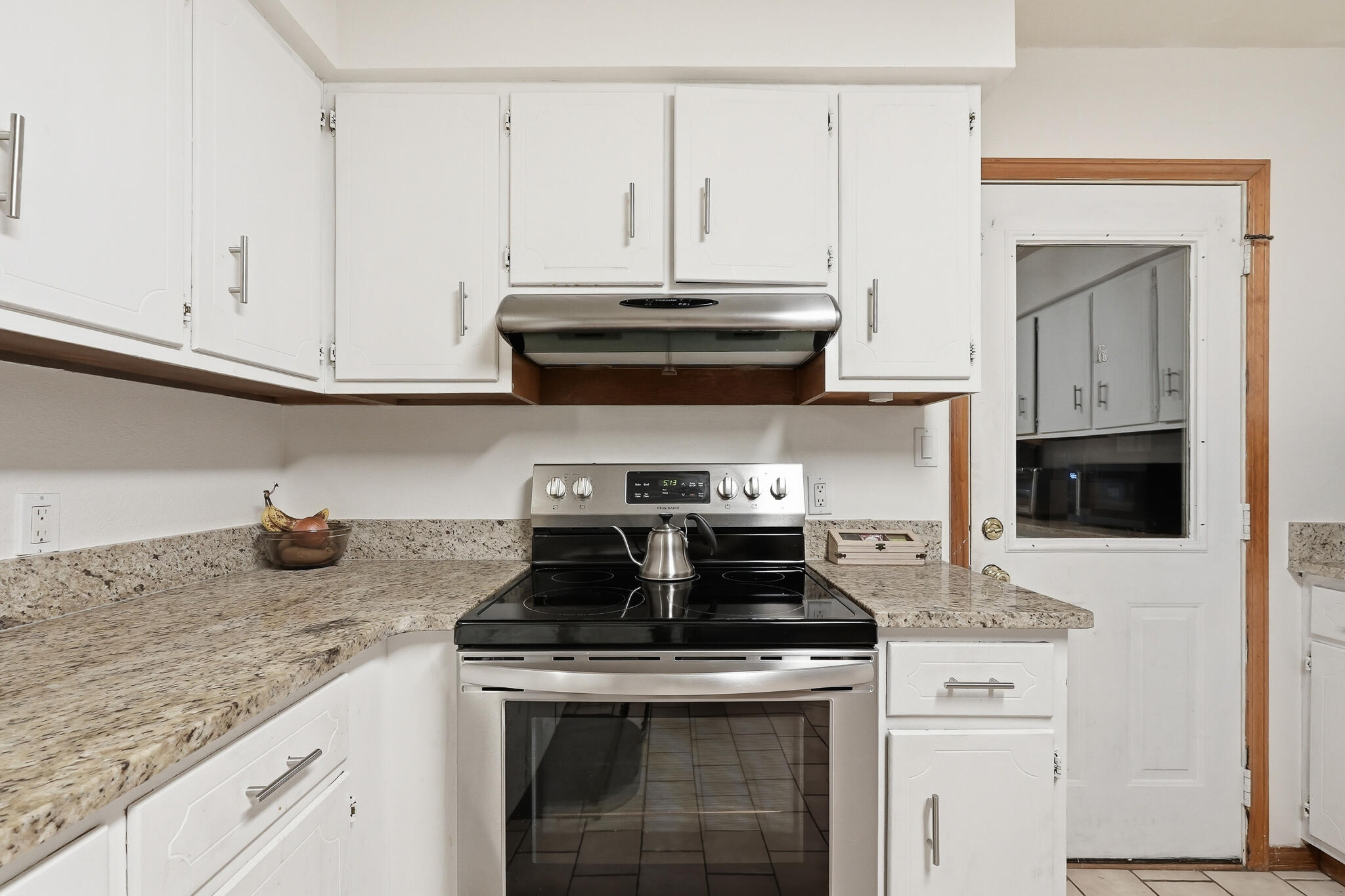 271 Willow Avenue Freeport, FL 32439 - Photo 34 of 57 a kitchen with granite countertop a stove sink and cabinets