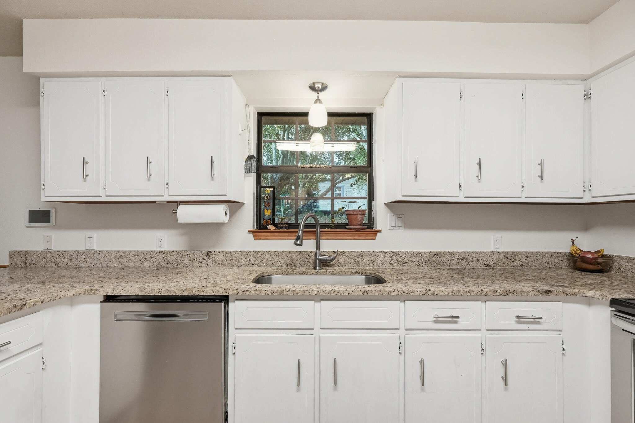 271 Willow Avenue Freeport, FL 32439 - Photo 37 of 57 a kitchen with granite countertop white cabinets and a white stove