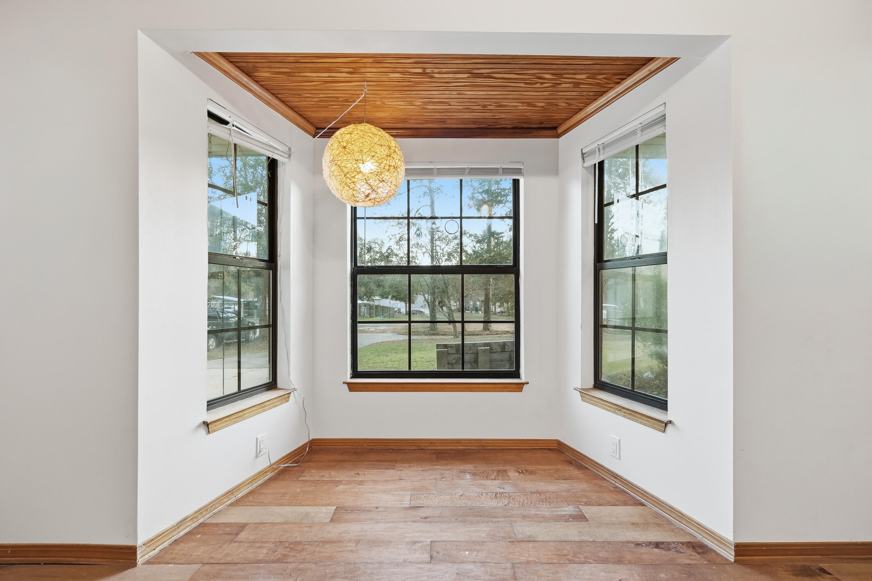 271 Willow Avenue Freeport, FL 32439 - Photo 40 of 57 a view of an empty room with a window and wooden floor