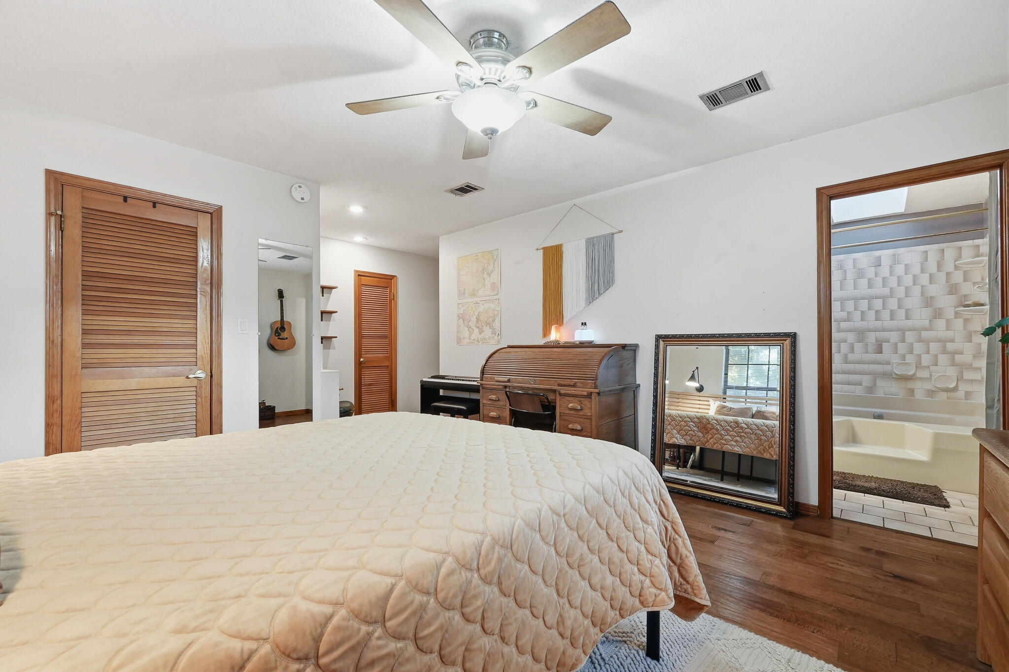 271 Willow Avenue Freeport, FL 32439 - Photo 50 of 57 a large bedroom with a bed and wooden floor