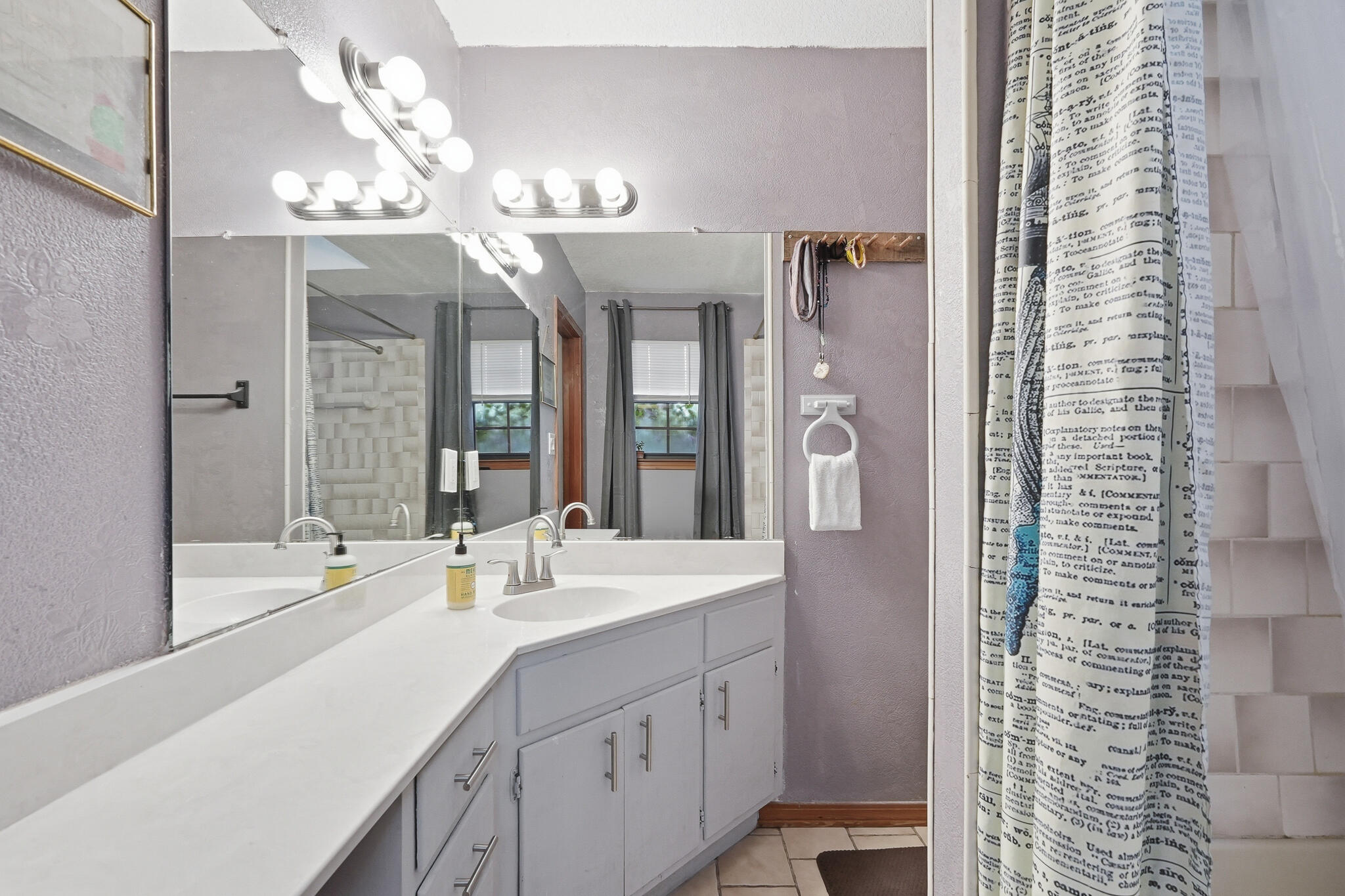 271 Willow Avenue Freeport, FL 32439 - Photo 52 of 57 a spacious bathroom with a shower a sink and a large mirror