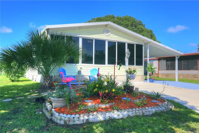 a front view of a house with porch and garden
