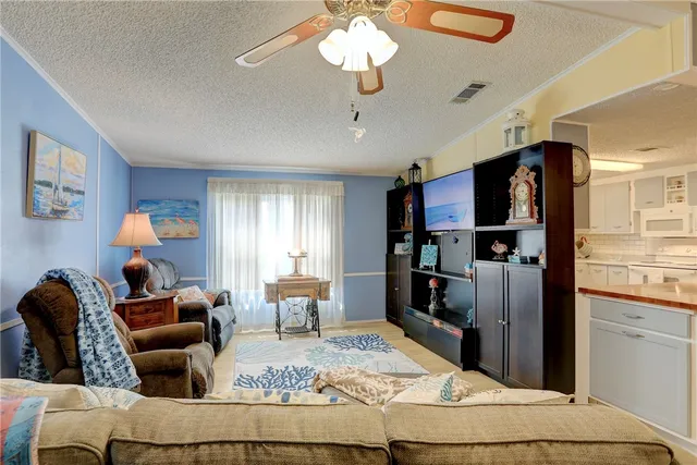 a living room with furniture and a kitchen