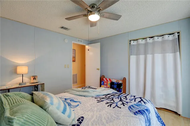 a bedroom with bed and a chandelier
