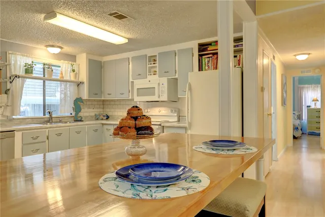 a kitchen with stainless steel appliances granite countertop a sink and cabinets