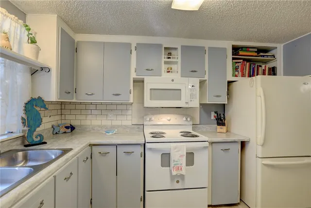 a kitchen with stainless steel appliances a refrigerator sink and cabinets