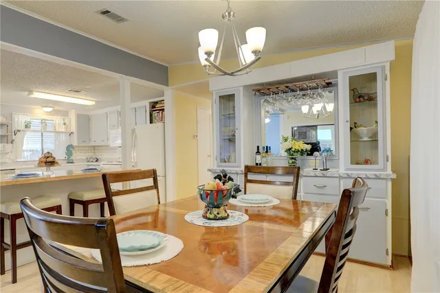 a view of a dining room with furniture and a chandelier