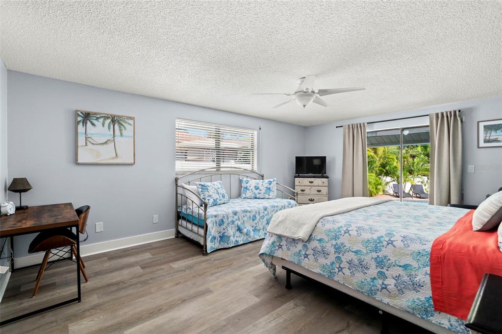 14030 79th Avenue Seminole, FL 33776 - Photo 14 of 33 a bedroom with a bed and a table in it