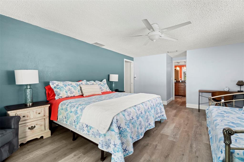 14030 79th Avenue Seminole, FL 33776 - Photo 16 of 33 a bedroom with a bed and a chandelier