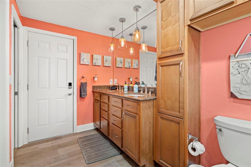 14030 79th Avenue Seminole, FL 33776 - Photo 17 of 33 a bathroom with a granite countertop sink and a mirror