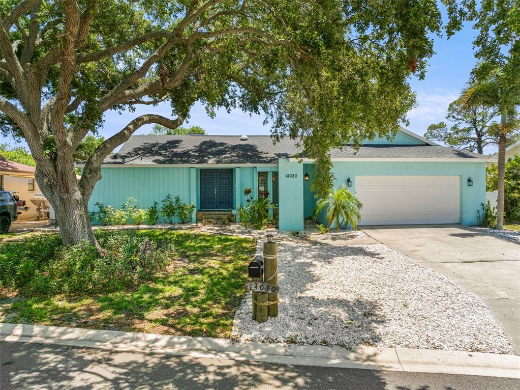 14030 79th Avenue Seminole, FL 33776 - Photo 2 of 33 a front view of a house with garden